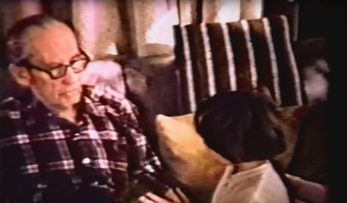 A blurred shot of an older man talking with young child.
